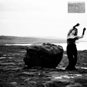 Black‑and‑white Mis O’ The Mountains album cover showing Jessie Monk raising her arms on a windswept beach with Celtic border elements.